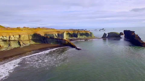 Dramatic aerial view of Iceland's black sand beach and cliffs Stock Footage 330284259