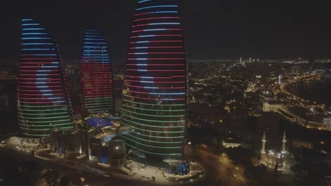 Dramatic aerial view of modern skyscrapers glowing against a dark city Stock Footage 341977925