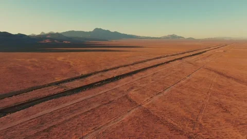 Dramatic Aerial View of Nevada Desert Highway with Mountain Backdrop Stock Footage 335181814