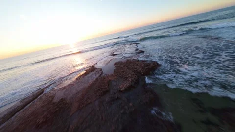 Dramatic aerial view of ocean meeting rugged coastline Stock Footage 344561040