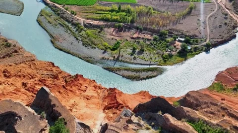 Dramatic Aerial View of River and Eroded Cliffs Xinjiang China Stock Footage 346585396