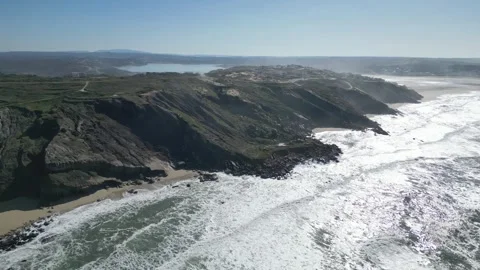 Dramatic aerial view of rugged cliffs and waves at Miradouro do Salgado, Nazaré Stock Footage 306674472