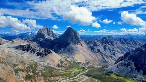 Dramatic Aerial View of Rugged Mountain Peaks and Winding Road Sichuan China Stock Footage 346570524