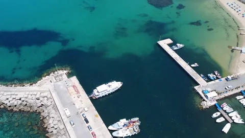 Dramatic Aerial View of a Serene Harbor With Boats and Clear Blue Waters Stock Footage 310951830