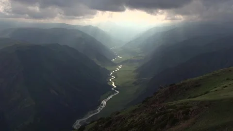 Dramatic Aerial View of Serene River Cutting Through Mountains Stock Footage 323298710