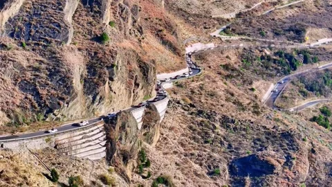 Dramatic Aerial View of Serpentine Mountain Road with Cars in China Stock Footage 346570525