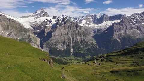 Dramatic aerial view of Snow-capped swiss alp mountains Schreckhorn and Stock Footage 239538856