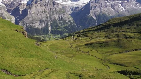 Dramatic aerial view of Snow-capped swiss alp mountains Schreckhorn and Stock Footage 240384673