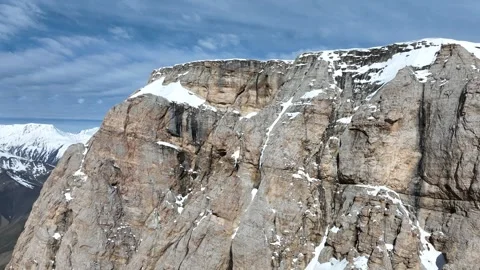 Dramatic Aerial View of Snow-Covered Mountains and Deep Valley Stock Footage 341905640