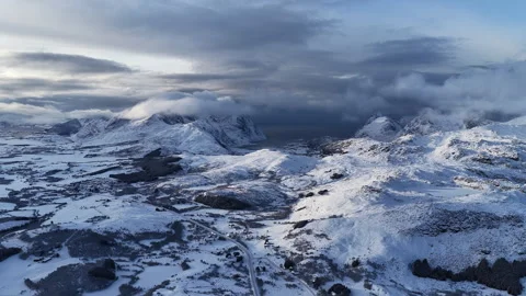 Dramatic aerial view of snowy winter mountains in lofoten islands, Norway 動画素材 343109638