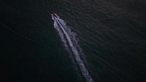 Dramatic Aerial View of Speedboat on Dark Ocean, Qingdao Stock Footage 330846102