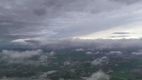 Dramatic aerial view of storm clouds above valley and foothills in China Stock Footage 337861115