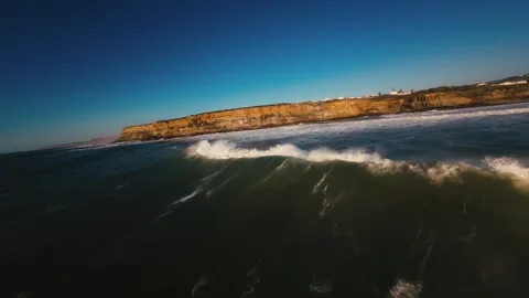 Dramatic aerial view of stormy waves hitting cliffside Stock Footage 339787764