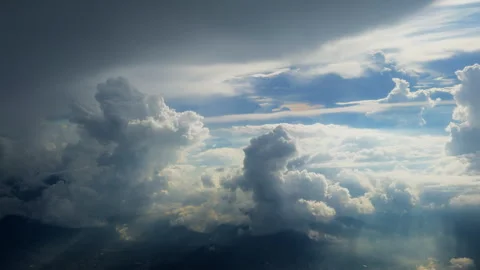 Dramatic Aerial View of Towering Cumulus Clouds Above Mountain Peaks at Sunset. Stock Footage 338360590