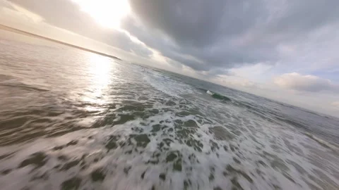 Dramatic aerial view of waves meeting beach with stone breakwater Stock Footage 344542528