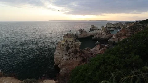 Dramatic Algarve Cliffs at Sunset with Ocean Waves Below Stock Footage 314451772