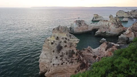 Dramatic Algarve Cliffs at Sunset with Ocean Waves Below Stock-Footage 314451784