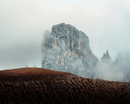 Dramatic Alpine Dolomites Peak Rising Through Storm Clouds Foggy at Italy Stock Photos