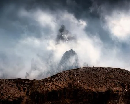 Dramatic Alpine Dolomites Peak Rising Through Storm Clouds Foggy at Italy Stock Photos