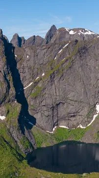Dramatic Alpine Lake and Waterfall in Lofoten Mountains Norway Stockfoto's