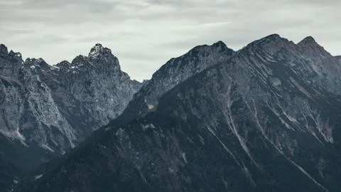 Dramatic alpine view of rocky mountains and cloudy sky, Dolomites, Italy Stock Photos