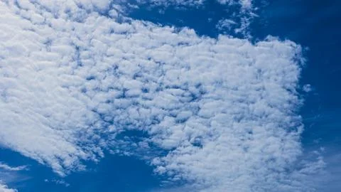 Dramatic Altocumulus Cloud Formation Across Deep Blue Sky Background Stock Photos