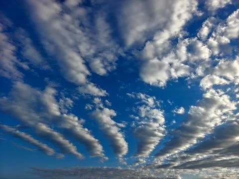 Dramatic Altocumulus Cloud Patterns Across a Deep Blue Sky Stock Photos