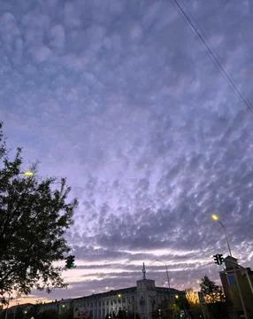 Dramatic Altocumulus Clouds at Sunset Over Cityscape, Atmospheric Sky with Stock Photos