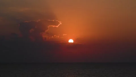 Dramatic and beautiful footage of the sun setting over the calm waters of the Ar Stock Footage 318647083