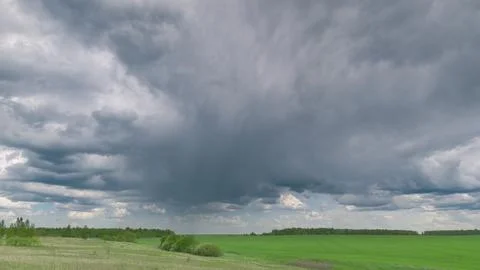 A Dramatic and Mesmerizing Cloud Formation Hovering Over Lush Green Fields and P Stock Photos