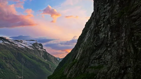 Dramatic and picturesque sunset along the steep mountain fjords of Geiranger Stock Footage 247926648