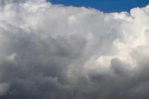 A Dramatic and Striking Cloud Formation Set Against a Bright Blue Sky Creating V 写真素材