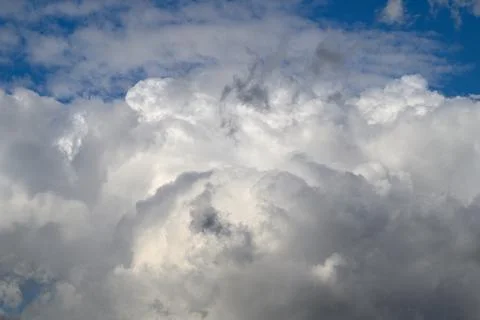 A Dramatic and Striking Cloud Formation Alongside a Bright Blue Sky Positioned O Stock Photos