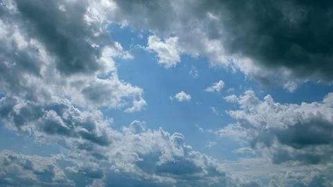 A Dramatic and Stunning Cloudscape Under a Bright, Clear Blue Sky Above Us Throu 写真素材