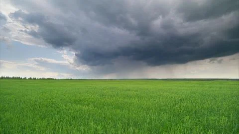 Dramatic and Unpredictable Weather Occurring Above a Lush and Vibrant Green Land Stock Photos