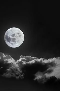 Dramatic atmosphere of bright and beautiful midnight full moon with clouds .. Stock Photos