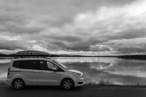 Dramatic autumn clouds reflection in Muonio lake, Lapland, Northern Finland Фото