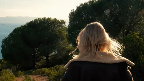 Dramatic back view of Woman Coming Down on The Path through forest Slow motion Stock Footage 246010799