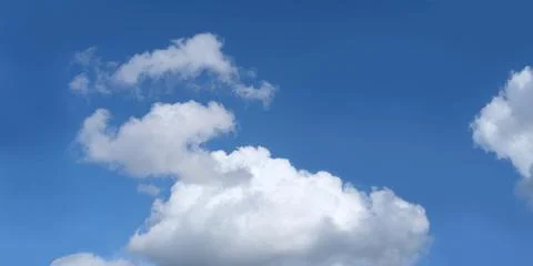 Dramatic background light sky gradient, close-up of beautiful white fluffy cl Stock Photos