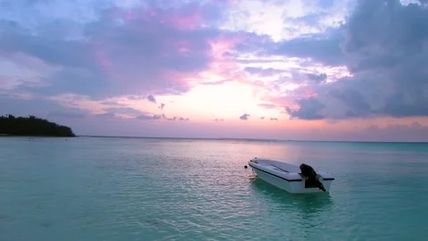 Dramatic Beach sunset view with alone boat in Maldive Island Stock Footage 131662947