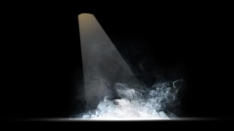 A dramatic beam of light shining down into a swirling cloud of white smoke .. Stock Photos