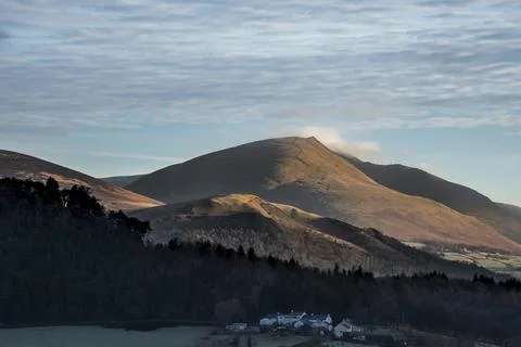 Dramatic beautiful Winter landscape image looking across countryside in Lak.. Stock Photos