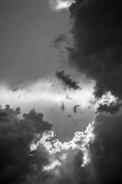 Dramatic black-and-white clouds create a moody and intense vertical scene. Stock Photos