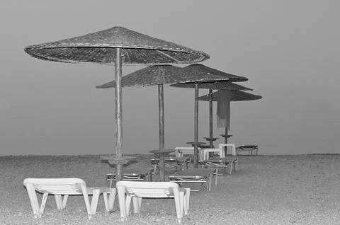A dramatic black and white fine art photography of a neat row of thatched str Stock Photos