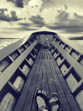 Dramatic black and white image of feet in boat, Inle lake, Myanmar Stock Photos