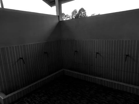 Dramatic Black and White Mosque Ablution Area with Water Faucets Stock Photos