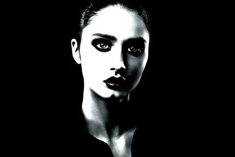 Dramatic black and white portrait of a beautiful girl on a dark background Stock Photos