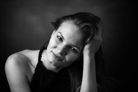 Dramatic black and white portrait of a beautiful girl on a dark background Stock Photos
