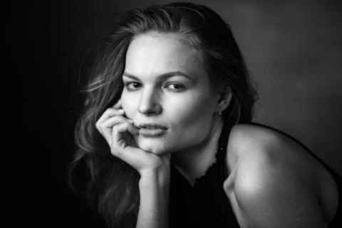 Dramatic black and white portrait of a beautiful girl on a dark background Stock Photos
