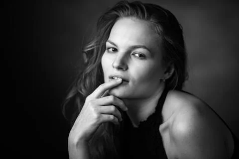 Dramatic black and white portrait of a beautiful girl on a dark background Stock Photos